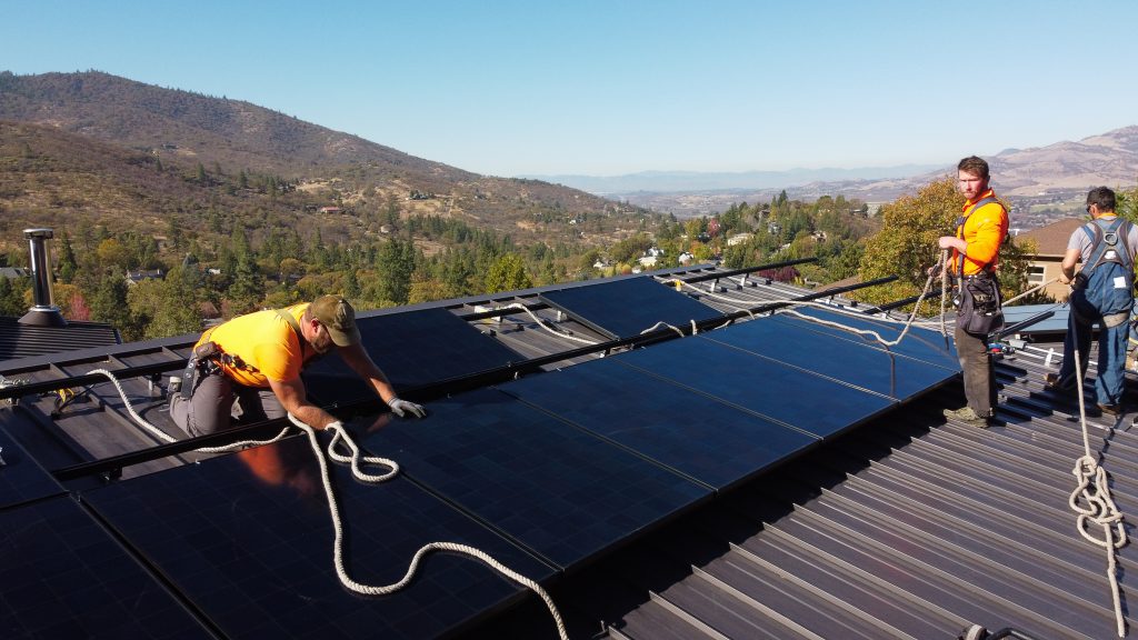 The True South Solar team installs solar panels.