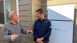 Owner Eric Hansen with a homeowner discussing their new Powerwall+