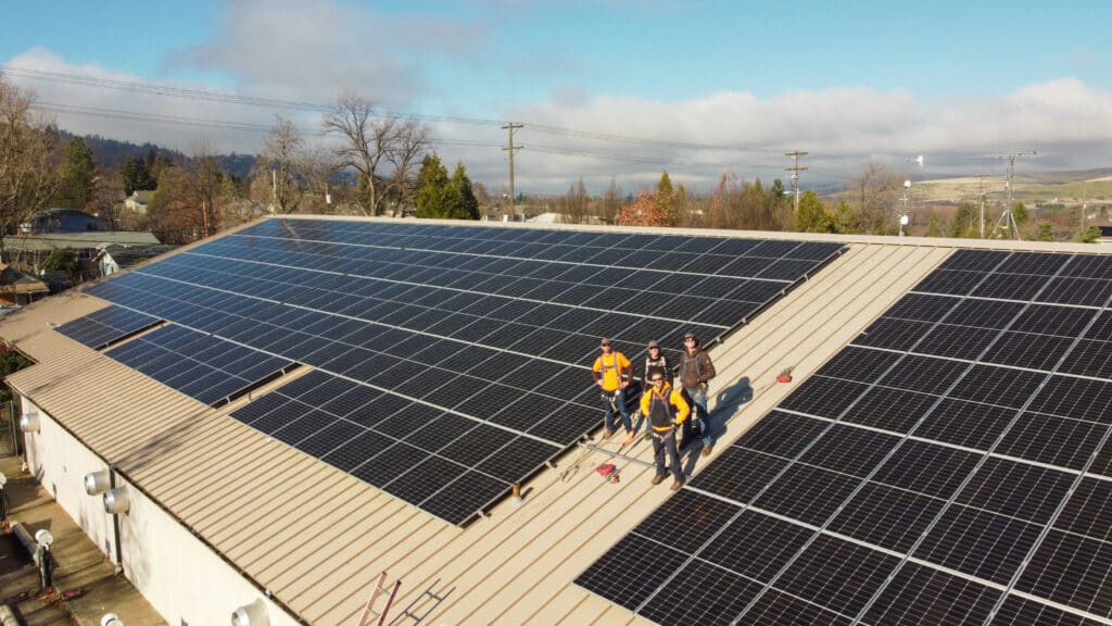 The True South Solar installation team at the newly-installed Ashland Solar Coop array on the City Services Building in Ashland.